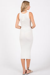 woman wearing a white ribbed midi dress with a fitted silhouette, standing with her back to the camera