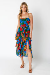 woman wearing a floral print tiered sundress with a high slit and adjustable straps