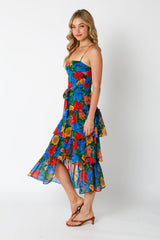 woman wearing a floral print blue and multi-colored midi dress with spaghetti straps and ruffle hemline