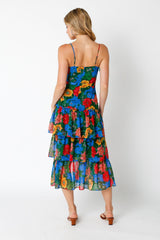 woman wearing a colorful floral tiered maxi dress with a spaghetti strap back detail