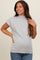woman wearing a light grey short sleeve maternity top with a high neckline and casual fit.