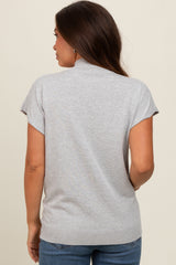woman wearing a light gray short sleeve maternity sweater, showing the back view with a relaxed fit