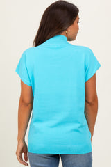 woman wearing a turquoise short sleeve maternity sweater with a high neckline, seen from the back