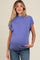 woman wearing a purple short sleeve maternity top with a visible baby bump and jeans
