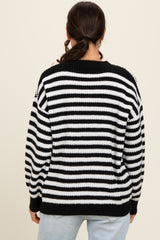 woman wearing a black and white striped oversized sweater, view from the back