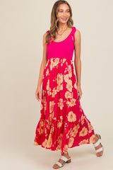 woman wearing a pink ribbed tank dress with floral skirt and ruffled hem, posing and smiling