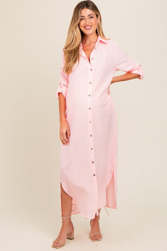 woman wearing a pink and white striped maternity dress with button details and side slits, showcasing her baby bump