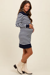 woman wearing a navy and white striped maternity dress and holding her baby bump