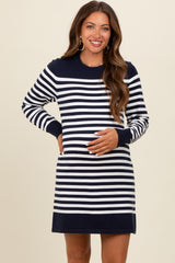 woman wearing a navy and white striped maternity dress and holding her baby bump