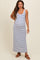 woman wearing a striped maternity maxi dress with a scoop neckline and side slits, showing her baby bump