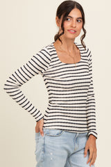 woman wearing a striped long sleeve top with a square neckline and paired with light blue jeans