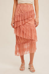 woman wearing a pink tiered lace midi skirt with ruffle details and a fitted waistband