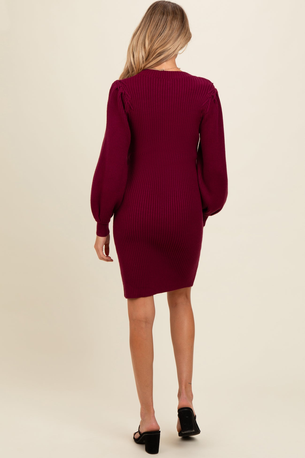 woman wearing a burgundy ribbed long sleeve maternity dress from the back