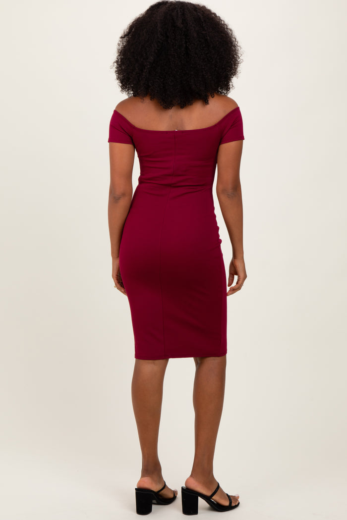 woman wearing a burgundy off-the-shoulder fitted midi dress with a bodycon silhouette and a sleek design