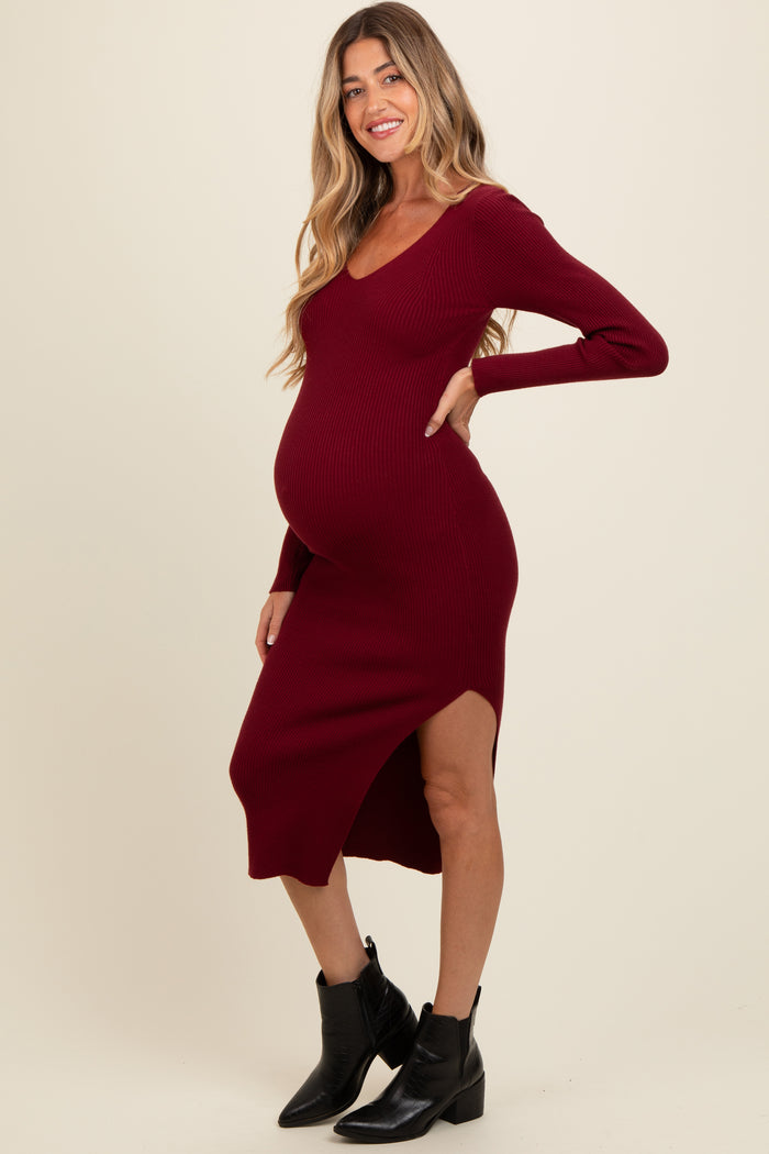 woman wearing a burgundy ribbed maternity dress with a side slit and a visible baby bump