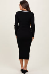 woman wearing a black ribbed maternity dress with long sleeves and a fitted silhouette, showing no baby bump