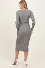 woman wearing a grey ribbed long sleeve maternity dress, showcasing a fitted silhouette and knee-length style from the back