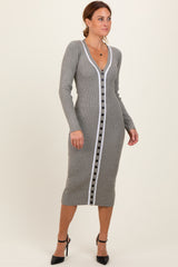 woman wearing a gray ribbed midi dress with a white button-down front and long sleeves, paired with high heels