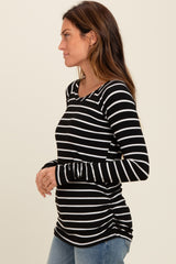 woman wearing a black and white striped long sleeve top with a scoop neckline and side ruching detail