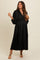 woman wearing a black maternity dress with a deep v-neck and gathered waist, showcasing her baby bump