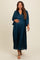 woman wearing a dark teal pleated maternity dress and gently cradling her baby bump