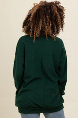 woman wearing a green oversized sweatshirt, back view, with curly hair and casual style