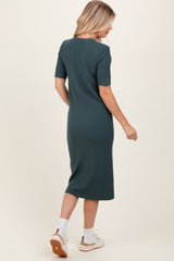 woman wearing a fitted green ribbed midi dress with short sleeves, seen from the back