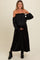 woman wearing a black off-the-shoulder maternity maxi dress and holding her baby bump