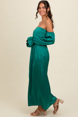 woman wearing a teal off-the-shoulder maxi dress with puff sleeves and ruched bodice