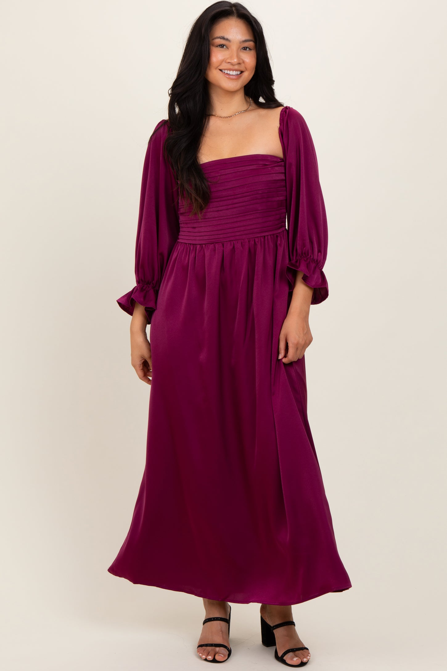 woman wearing a burgundy long sleeve maxi dress with a square neckline and puffed sleeves