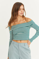 woman wearing a green and white striped off-the-shoulder crop top with long sleeves and gray tailored pants