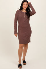 woman wearing a brown ribbed long sleeve henley dress with button details