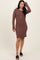 woman wearing a brown ribbed long sleeve henley dress with button details