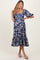 woman wearing a navy blue floral print maternity dress with a square neckline and tiered hem, showcasing her baby bump