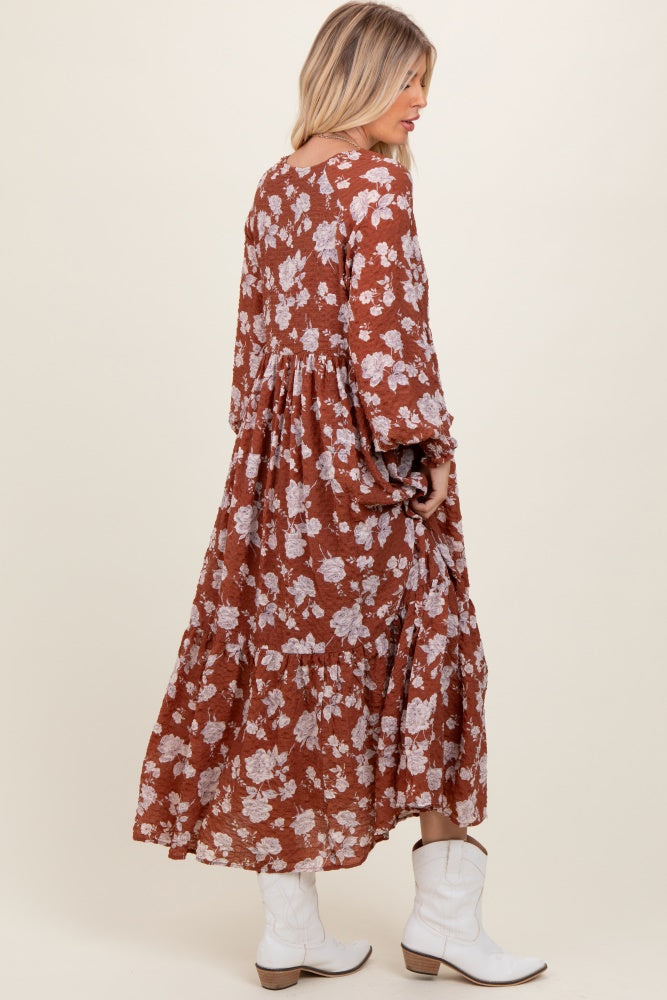 woman wearing a brown floral long sleeve maxi dress and white cowgirl boots, shown from the back