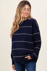 woman wearing a navy blue striped maternity sweater with a relaxed fit and long sleeves