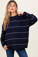 woman wearing a navy blue striped oversized maternity sweater with long sleeves and a relaxed fit