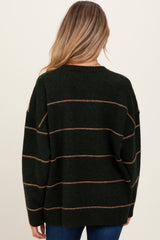 woman wearing a dark green maternity sweater with tan stripes, showing the back view and loose fit