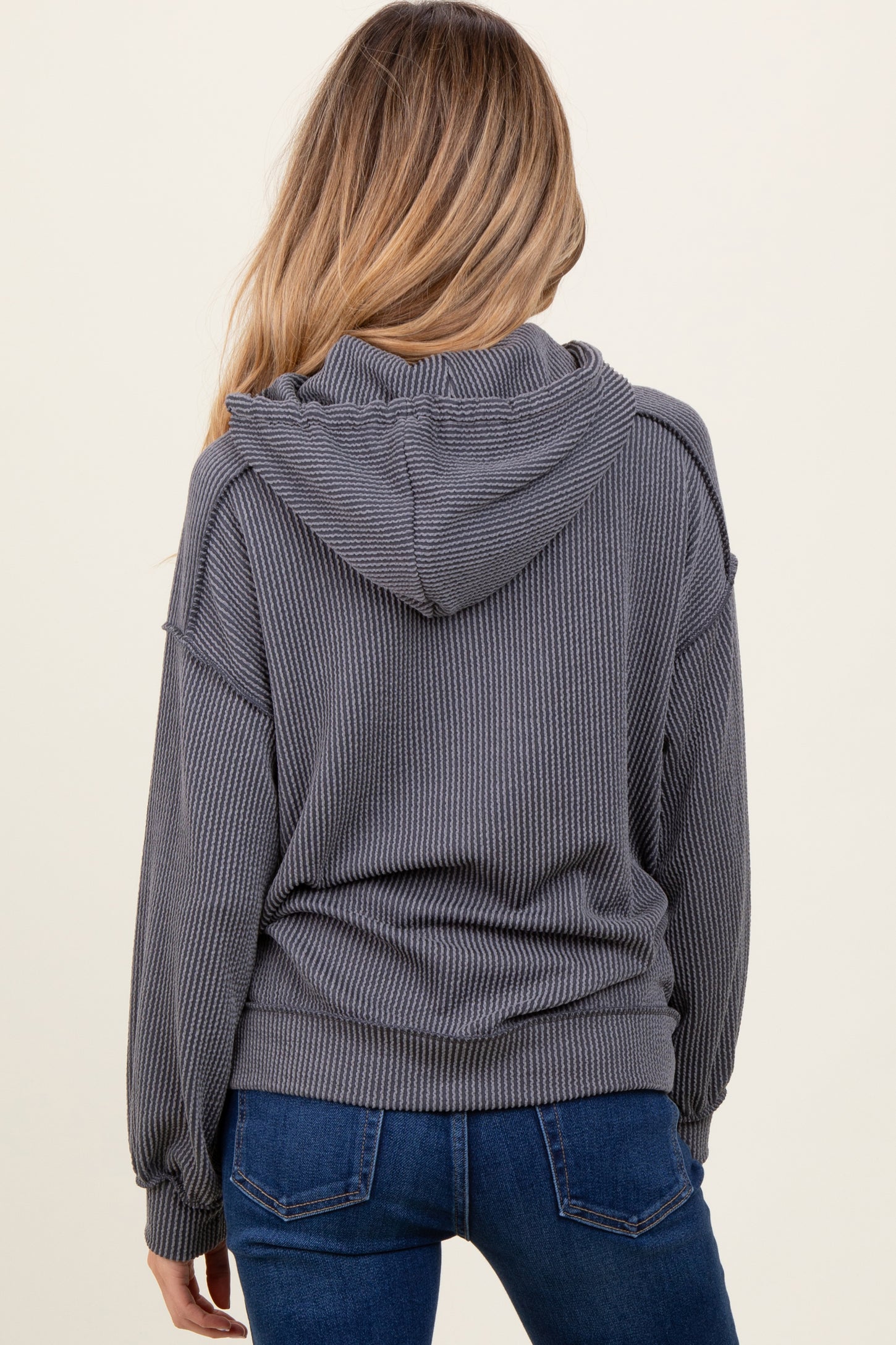 maternity wear in dark gray ribbed knit hoodie with a hood and relaxed fit, shown from the back
