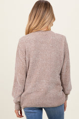 woman wearing a soft beige long sleeve maternity sweater with ribbed texture, seen from the back