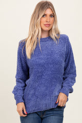 woman wearing a textured purple sweater with a relaxed fit and ribbed hem, paired with blue jeans