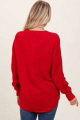 woman wearing a red oversized knit sweater from the back with long sleeves and a relaxed fit