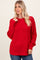 woman wearing a red oversized knit sweater with long sleeves and a relaxed fit