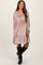 woman wearing a dusty rose maternity dress with smocking detail and tiered hem, paired with knee-high black boots