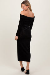 woman wearing a black off-the-shoulder velvet midi dress with long sleeves and a fitted silhouette