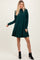 woman wearing a dark green long sleeve ribbed dress with a relaxed fit and black ankle boots