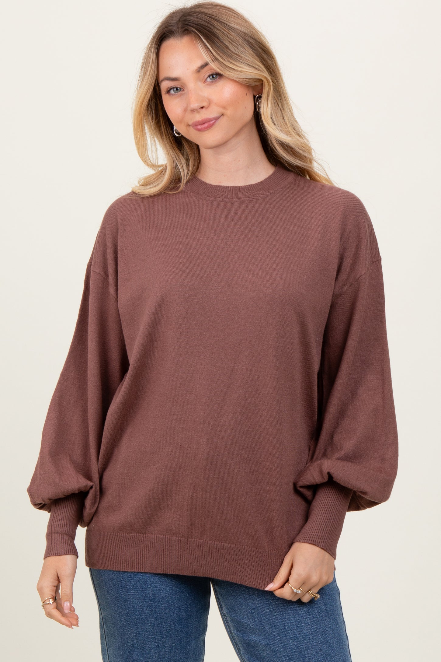 woman wearing a brown oversized sweater with balloon sleeves and a relaxed fit