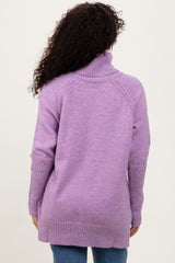woman wearing a lavender oversized turtleneck sweater, viewed from the back