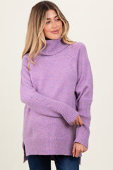 woman wearing a light purple maternity sweater with a turtleneck and side slits