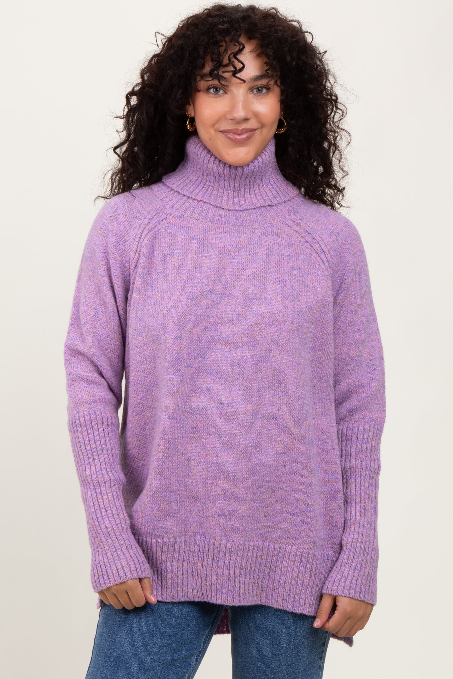 woman wearing a cozy lavender turtleneck sweater with ribbed detailing and relaxed fit